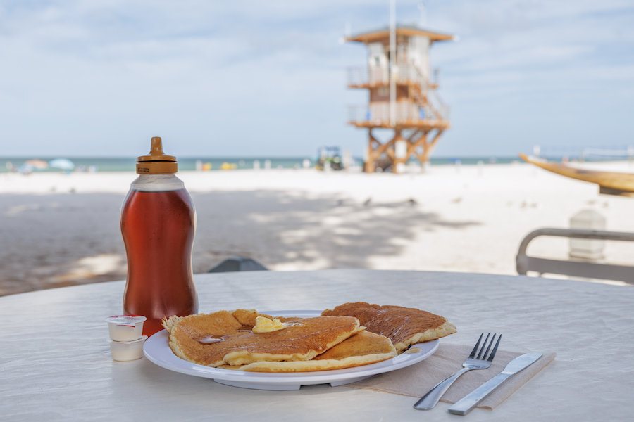 pancakes with a view of the beach and a lifeguard tower