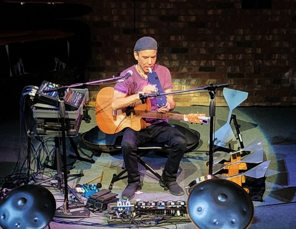 Picture of artist playing guitar and other instruments