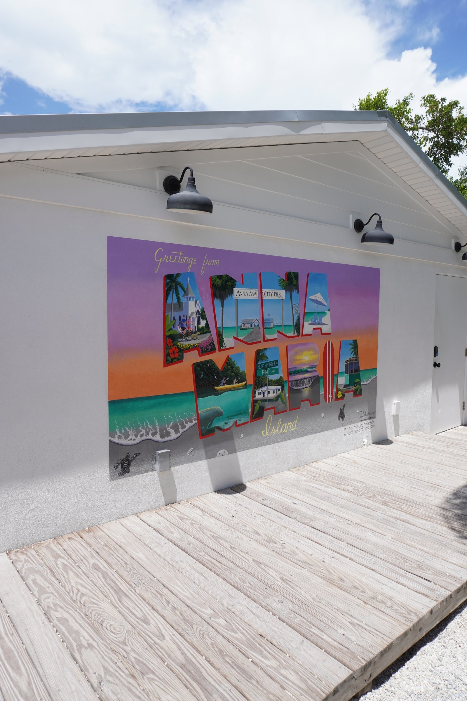 a vintage inspired postcard painted on a wall reading GREETINGS FROM ANNA MARIA ISLAND