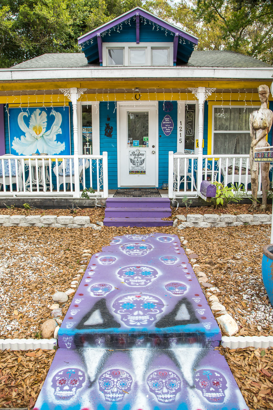 a brightly painted bungalow home with painted sugar skulls for decoration