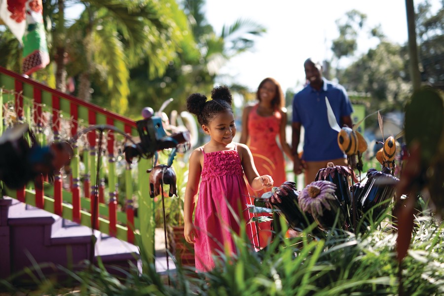 child looking at pretty things in village of the arts