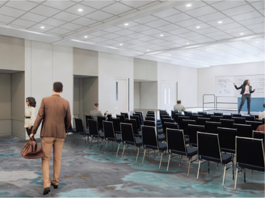A rendered image of a large ballroom is filled with chairs arranged theater-style with a few people walking amongst them while someone speaks on a stage setup, depicting the incredible renovations made to the Bradenton Area Convention Center in Florida's Gulf Coast.