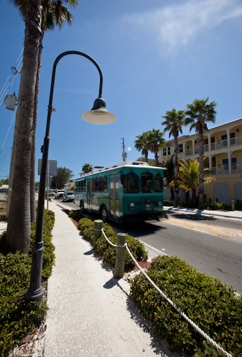blue/green trolley driving down Gulf Drive on Anna maria island